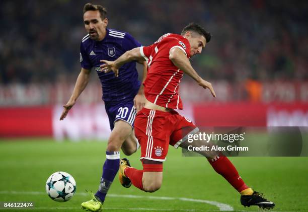 Robert Lewandowski of Muenchen is fouled for a penalty by Sven Kums of RSC Anderlecht during the UEFA Champions League group B match between Bayern...