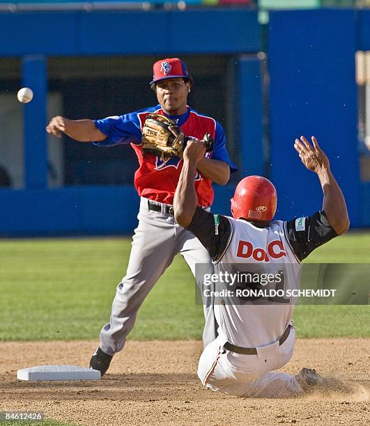 Anderson Hernandez of Tigres del Licey of Dominican Republic puts out Jorge Padilla of Leones de Ponce of Puerto Rico during the Baseball Caribbean...