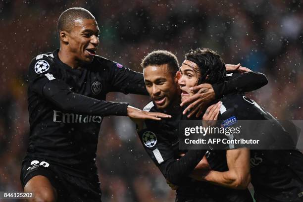 Paris Saint-Germain's Brazilian striker Neymar celebrates with Paris Saint-Germain's French striker Kylian Mbappe and Paris Saint-Germain's Uruguayan...