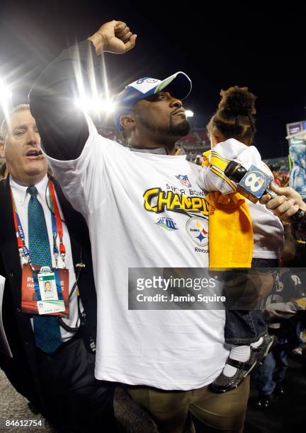Head coach Mike Tomlin of the Pittsburgh Steelers holds his daughter Harlyn Quinn as he celebrates their 27-23 win against the Arizona Cardinals...
