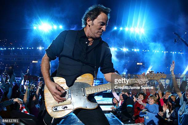 Musician Bruce Springsteen and the E Street Band perform at the Bridgestone halftime show during Super Bowl XLIII between the Arizona Cardinals and...