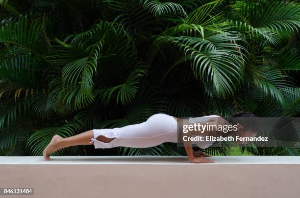 Young Woman Doing Yoga Meditation and Stretching Exercises