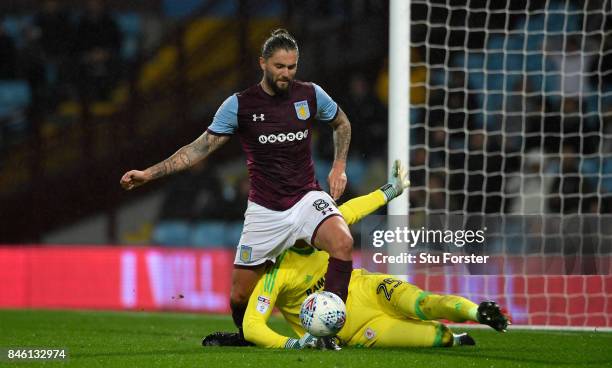 Villa player Henri Lansbury goes down under the challenge of Middlesbrough goalkeeper Darren Randolph during the Sky Bet Championship match between...