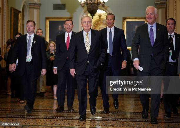 Senate Majority Leader Mitch McConnell walks with members of the Senate Republican leadership before answering questions at the U.S. Capitol on...