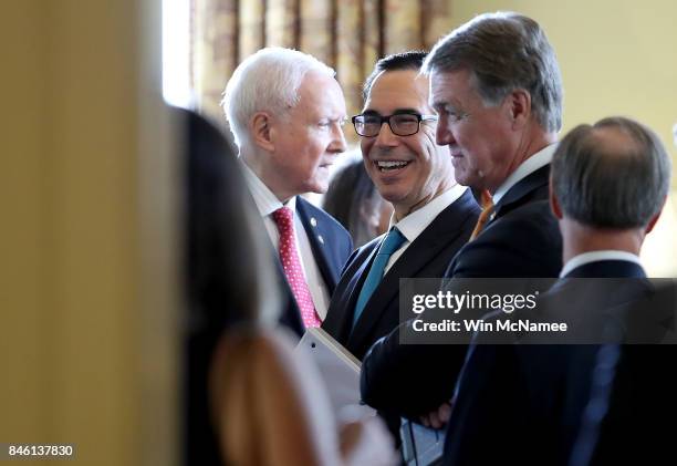 Secretary of the Treasury Steven Mnuchin talks with Sens. David Perdue and Orrin Hatch in the office of Senate Majority Leader Mitch McConnell...