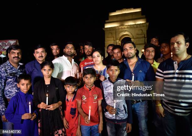 Several parents and family friends gather at India Gate to hold a candle light vigil in support of class 2 student Pradyuman Thakur, who was found...