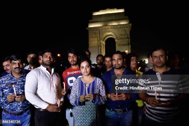 Several parents and family friends gather at India Gate to hold a candle light vigil in support of class 2 student Pradyuman Thakur, who was found...