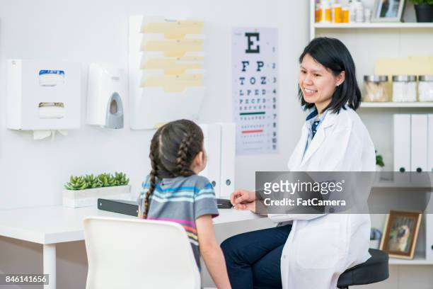 talking with optometrist - eye chart stock pictures, royalty-free photos & images