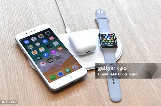 An AirPower mat is seen charging multiple devices during a media event at Apple's new headquarters in Cupertino, California on September 12, 2017. /...