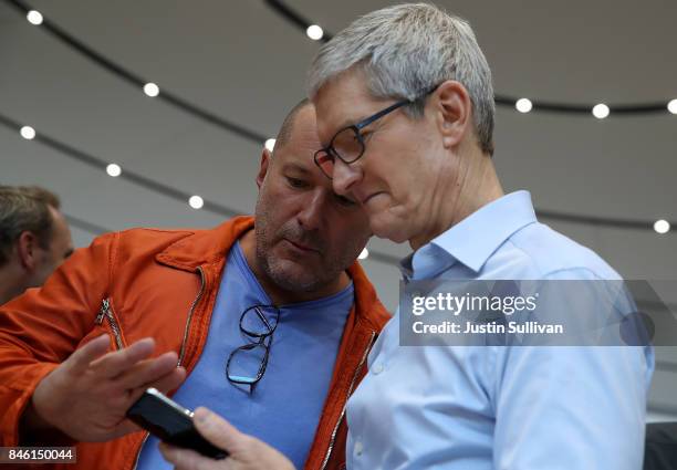 Apple CEO Tim Cook and Apple chief design officer Jonathan Ive look at the new Apple iPhone X during an Apple special event at the Steve Jobs Theatre...