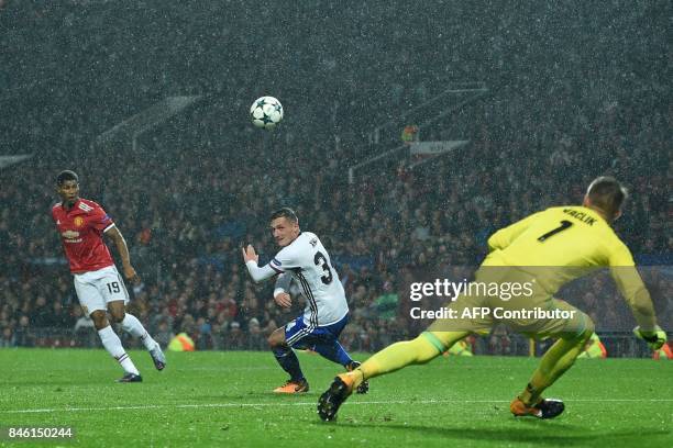 Manchester United's English striker Marcus Rashford scores their third goal during the UEFA Champions League Group A football match between...