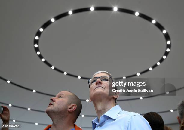 Apple CEO Tim Cook and Apple chief design officer Jonathan Ive tour the display area during an Apple special event at the Steve Jobs Theatre on the...