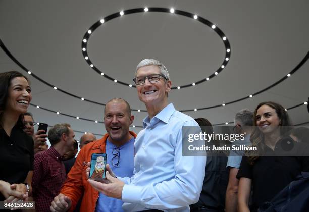 Apple CEO Tim Cook and Apple chief design officer Jonathan Ive look at the new Apple iPhone X during an Apple special event at the Steve Jobs Theatre...