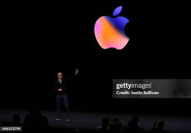 Apple CEO Tim Cook waves to the audience during an Apple special event at the Steve Jobs Theatre on the Apple Park campus on September 12, 2017 in...