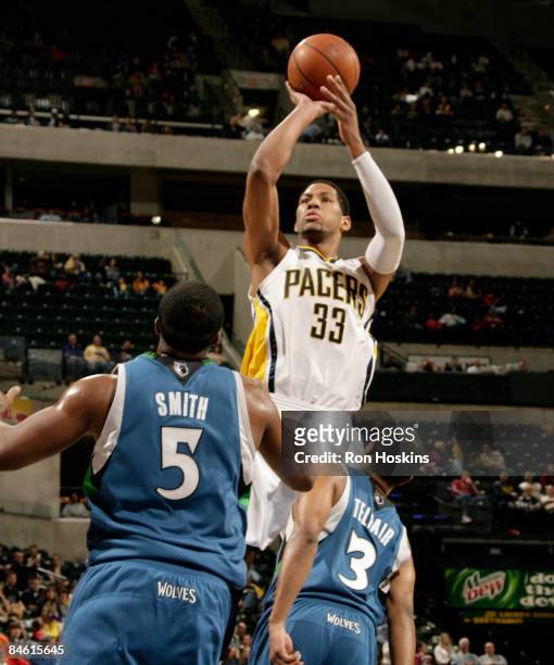 Danny Granger of the Indiana Pacers shoots over Craig Smith and Sebastian Telfair of the Minnesota Timberwolves at Conseco Fieldhouse February 3,...