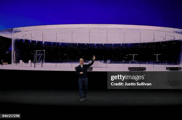 Apple CEO Tim Cook waves to the audience during an Apple special event at the Steve Jobs Theatre on the Apple Park campus on September 12, 2017 in...