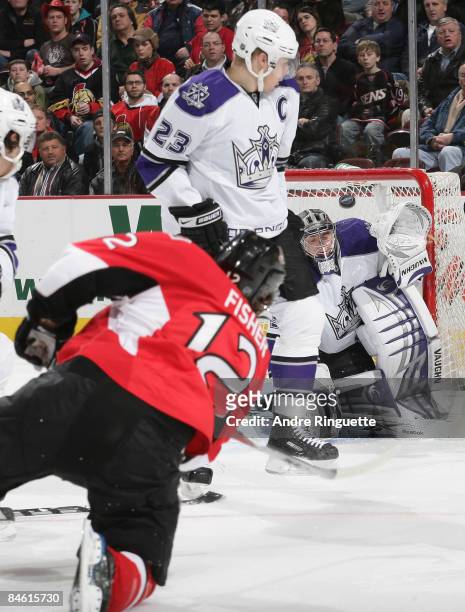 Mike Fisher of the Ottawa Senators fires a shot past Dustin Brown of the Los Angeles Kings as Jonathan Quick of the Los Angeles Kings makes a save at...