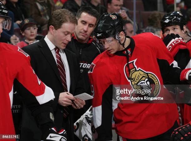 Cory Clouston of the Ottawa Senators talks with Jason Spezza of the Ottawa Senators behind the bench prior to his first career NHL game as head coach...