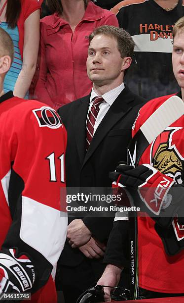 Cory Clouston of the Ottawa Senators looks on from behind the bench during the singing of the national anthems in his first career NHL game as head...