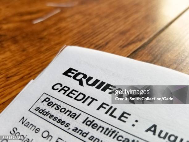 Close-up of the upper corner of a consumer credit report from the credit bureau Equifax, with text reading Credit File and Personal Identification,...