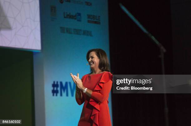 Meredith Attwell Baker, chief executive officer of Cellular Telecommunications Industry Association , applauds on stage during the Mobile World...