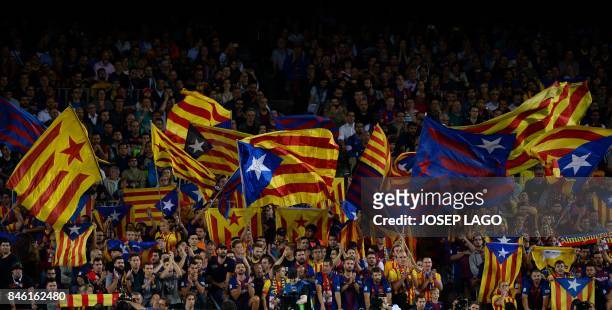 Barcelona's fans wave 'Esteladas' before the UEFA Champions League Group D football match FC Barcelona vs Juventus at the Camp Nou stadium in...