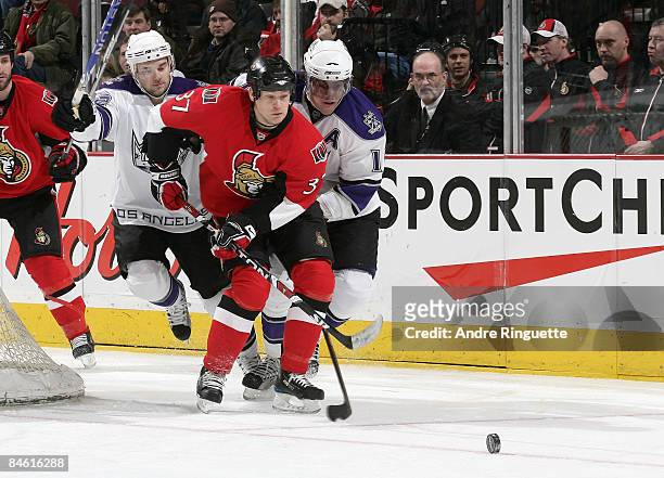 Dean McAmmond of the Ottawa Senators skates for a loose puck against Anze Kopitar of the Los Angeles Kings at Scotiabank Place on February 3, 2009 in...