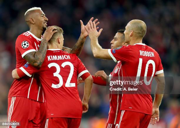 Joshua Kimmich of Muenchen celebrate with team mate Jerome Boateng after he scores the 3rd goal during the UEFA Champions League group B match...