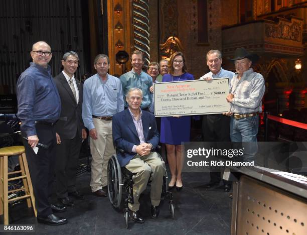 The San Antonio Auto Dealers Association presents a $20,000 check to the Rebuild Texas Relief Fund to Founder/CEO of Messina Touring Group Louis...