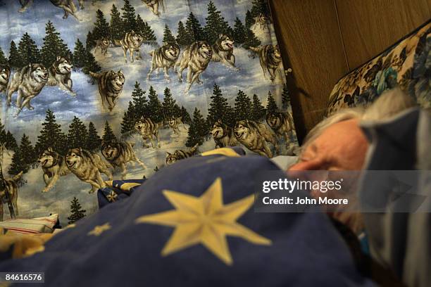 Lyla Coburn sleeps in a camper after she and her son Clifford Coburn were evicted from their foreclosed home on February 3, 2009 in Brighton,...