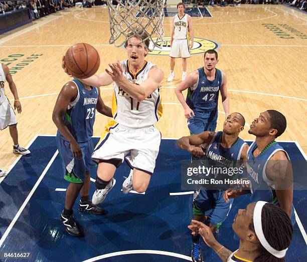 Mike Dunleavy of the Indiana Pacers lays the ball up on Al Jefferson and Randy Foye of the Minnesota Timberwolves at Conseco Fieldhouse February 3,...