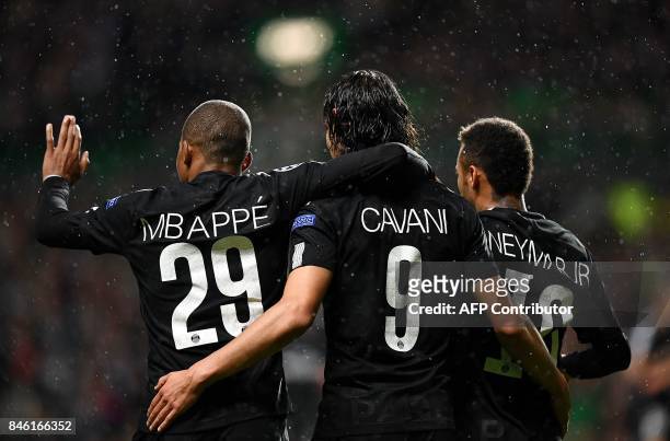 Paris Saint-Germain's Brazilian striker Neymar celebrates with Paris Saint-Germain's French striker Kylian Mbappe and Paris Saint-Germain's Uruguayan...