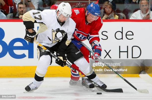 Petr Sykora of the Pittsburgh Penguins battles for the puck against Sergei Kostitsyn of the Montreal Canadiens during their NHL game at the Bell...