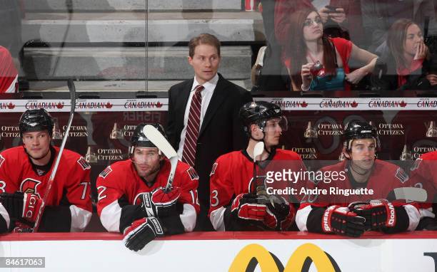 Cory Clouston of the Ottawa Senators looks on from behind the bench in his first career NHL game as head coach against the Los Angeles Kings at...
