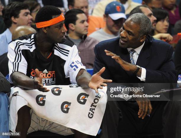 The Charlotte Bobcats' Kwame Brown, left, and assistant coach Charles Oakley talk after Brown was called for a technical foul following a dunk...