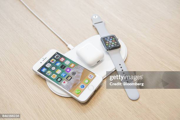 The Apple Inc. IPhone 8, Airpods, and Apple Watch sit on the AirPower charger during an event at the Steve Jobs Theater in Cupertino, California,...