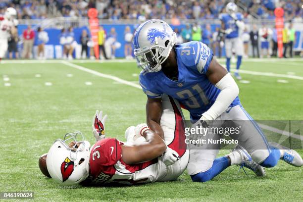 Arizona Cardinals running back David Johnson is tackled by Detroit Lions defensive back D.J. Hayden during the first half of an NFL football game...