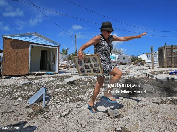 Laura Costello avoids tripping on a rock where her trailer once stood at the Seabreeze trailer park along the Overseas Highway in the Florida Keys on...