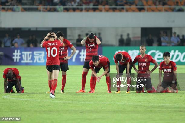 Players of Guangzhou Evergrande react during the penalty of the AFC Champions League 2017 Quarterfinals 2nd leg between Shanghai SIPG and Guangzhou...