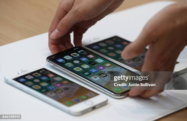 The new iPhone 8, iPhone X and iPhone 8S are displayed during an Apple special event at the Steve Jobs Theatre on the Apple Park campus on September...