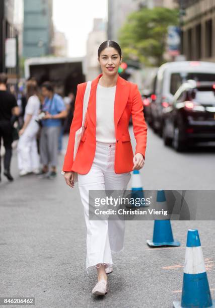 Caroline Issa wearing white pants, red jacket seen in the streets of Manhattan outside Gabriela Hearst during New York Fashion Week on September 12,...