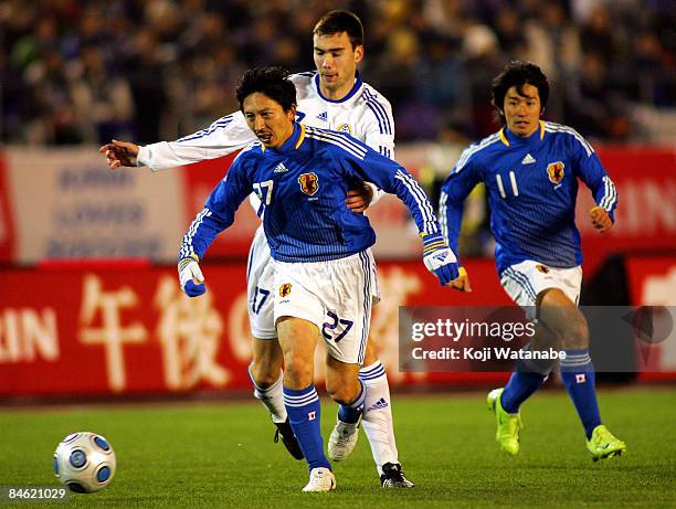 Hideo Hashimoto of Japan escapes the challenge of a Finnish player during the Kirin Challenge Cup 2009 match between Japan and Finland at the...