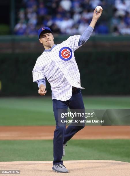 Tour golfer Jordan Spieth throws a ceremonial first pitch before the Chicago Cubs take on the New York Mets at Wrigley Field on September 12, 2017 in...