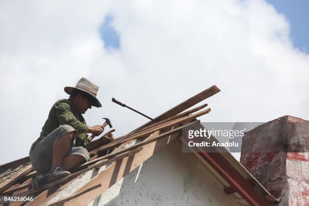 People repair damaged buildings in the northern coast of Ciego de Avila province of Cuba after Hurricane Irma passed through the area on September...