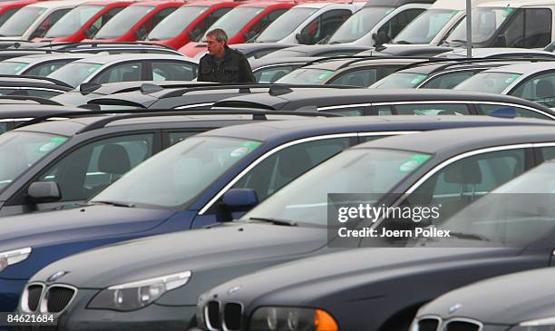 Customers are looking for a new car at a car dealer on February 4, 2009 in Bockel, Germany. The German Government supports the automobile industry in...