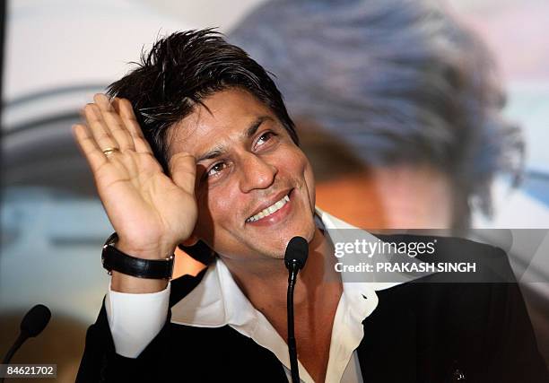 Bollywood star and Tag Heuer Brand Ambassador Shahrukh Khan waves to fans during the inauguaration of the Tag Heuer concept boutique in New Delhi on...