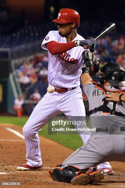 Nick Williams of the Philadelphia Phillies gets hit by a pitch in the third inning against the Miami Marlins at Citizens Bank Park on September 12,...