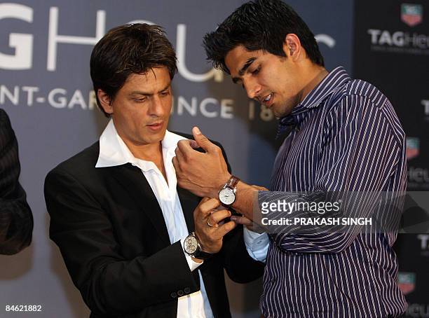 Bollywood star and Tag Heuer Brand Ambassador Shahrukh Khan presents a Tag Heuer watch to Indian Olympic bronze medallist boxer Vijender Singh during...