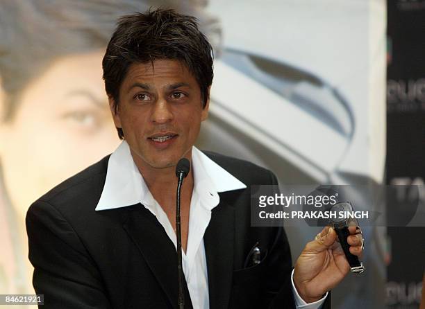 Bollywood star and Tag Heuer Brand Ambassador Shahrukh Khan shows off his watch during the inauguaration of the Tag Heuer concept boutique in New...