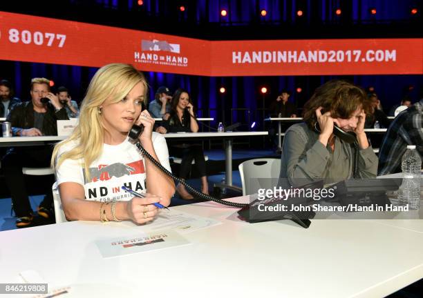 In this handout photo provided by Hand in Hand, Reese Witherspoon and Amy Grant attend Hand in Hand: A Benefit for Hurricane Relief at the Grand Ole...